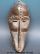 An African tribal Dan mask with raised studwork decoration (length 31cm)