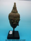 A post Khmer bronze buddha head on mounted base