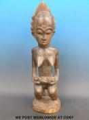 An African tribal Baule maternity figure of a woman holding a child