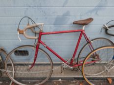 An R O Harrison racing bike together with a collection of spare parts, some in original boxes.