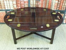 A mahogany and oak brass hinged butler's table