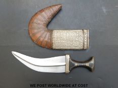 A Middle Eastern jambiya dagger with inlaid horn handle and white metal and bound leather sheath