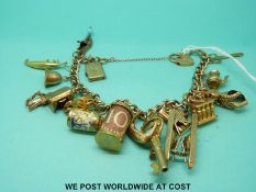 A 9ct gold charm bracelet with 19 9ct gold, 18ct and yellow metal charms (56.