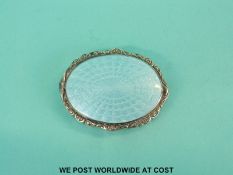 A white metal powder compact with aqua guilloche enamel to both slides, stamped to rim 935 S,