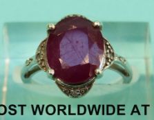 A 9ct white gold ring set with a ruby and diamonds (Size J, 3.