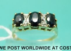 A yellow metal ring marked 18ct gold set with sapphires and diamonds (size T)
