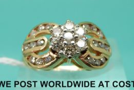 A 9ct gold ring set with diamonds in a cluster with buckle decoration (size K)