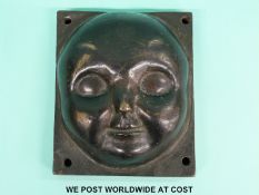 A 19thC / 20thC bronze plaque or mould of a cherub's face,