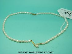 A single strand pearl necklace with a 9ct gold centre section