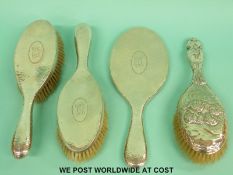 A hallmarked silver hammered hand mirror together with matching pair of brushes and another silver