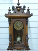 A late 19thC Vienna style wall clock with inset enamelled decoration,