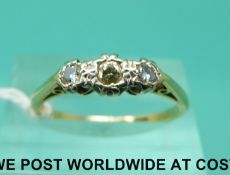 An 18ct gold ring set with three diamonds (size P)