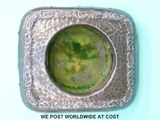 A hallmarked silver pocket watch stand with embossed decoration,