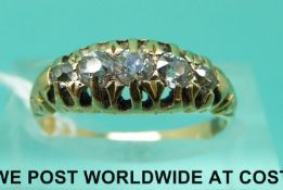 An Edwardian yellow metal ring set with five diamonds (size M)