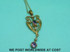 A 9ct gold pendant set with amethysts and seed pearls on a 9ct gold chain