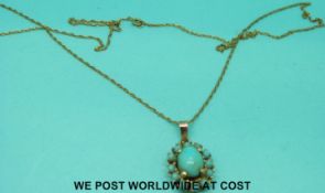 A Victorian yellow metal pendant set with turquoise on a 9ct gold chain