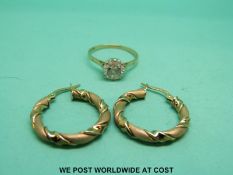 A pair of 9ct gold earrings and a 9ct gold ring set with a cubic zirconia