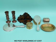 A hallmarked silver-mounted mirror and brush, brass and copper caskets,