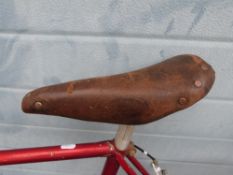 An R O Harrison racing bike together with a collection of spare parts, some in original boxes.