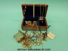An inlaid musical jewellery box containing costume jewellery,