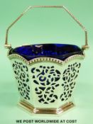 A Victorian blue glass linered hallmarked silver swing handled octagonal basket,