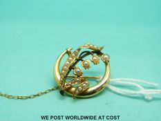 An Edwardian 15ct gold brooch set with seed pearls in the form of lily of the valley.
