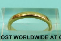 A yellow metal wedding band marked 18k Tiffany & Co (Size J, 3.