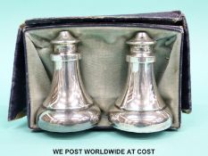 A cased hallmarked silver salt and pepper set