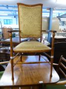 An Edwardian upholstered mahogany armchair with inlaid surround,