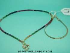 A necklace of multicoloured sapphire beads and a silver bracelet