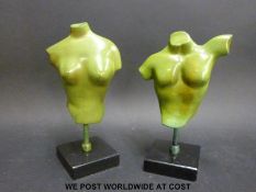 A pair of bronze verdigris style male and female torsos on black bases (signed,