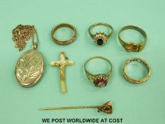 Three silver rings, one set with a diamond and rubies, a yellow metal buckle ring set with a garnet,