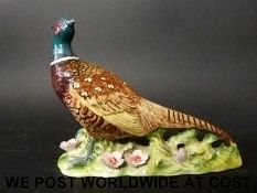 A first version Beswick pheasant with flowers in relief