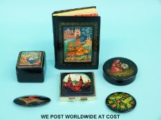 A collection of hand-painted Russian lacquer ware boxes, notebook,