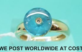 A 14ct gold ring set with a blue topaz and a diamond (size N)