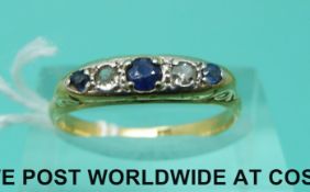 An 18ct gold ring set with diamonds and sapphires (size M)