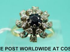 An 18ct gold ring set with a sapphire surrounded by diamonds (size M)