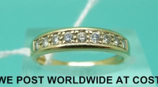 A 9ct gold ring set with nine diamonds (size M)