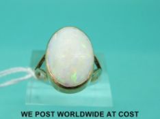 A 9ct gold ring set with a large oval opal cabochon (size Q)
