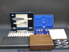 A collection of cased plated cutlery including fish servers,