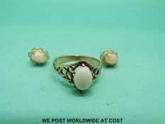 A 9ct gold ring set with an opal and matching earrings