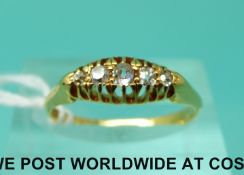 An 18ct gold ring set with five diamonds,