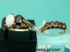 A 9ct gold ring set with garnet (size K) and a 9ct gold ring set with garnets and an opal (size N)