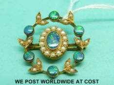 A yellow metal brooch set with boulder opal doublets and seed pearls