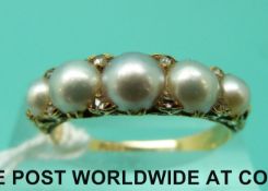 An 18ct gold ring set with pearls and diamonds (size N)