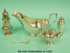 Two hallmarked silver peppers and an open salt,