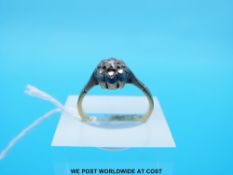A yellow metal ring marked 18ct set with diamonds in a cluster (Size N)