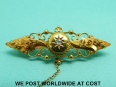 A 15ct gold brooch set with a diamond,