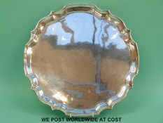 A hallmarked silver tray with shaped edge, Birmingham 1969, diameter 35.