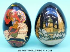Two Russian lacquer eggs, one decorated with a Russian palace, the other a figure on horseback,